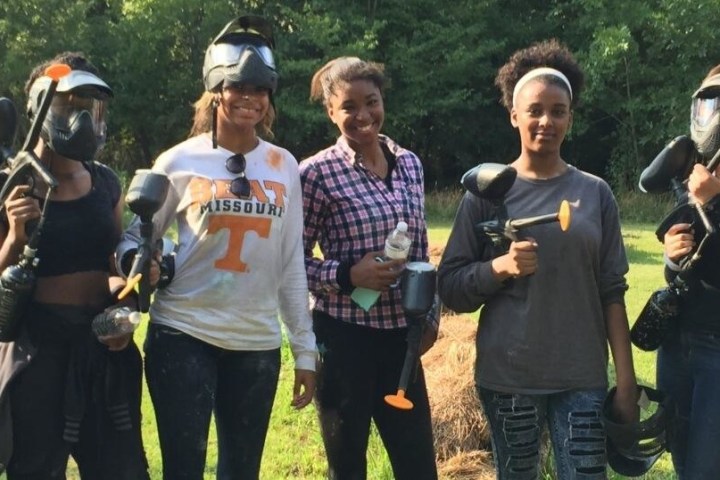 a group of women playing paintball